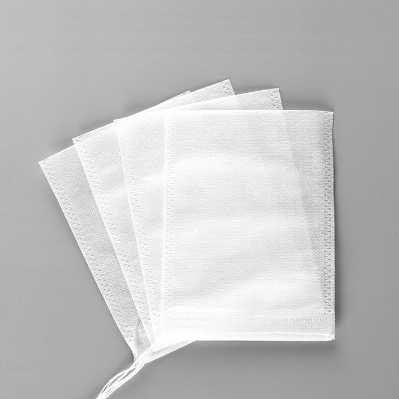 Four white juicer bags on a gray background