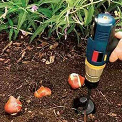 Person using a gardening tool to plant bulbs in soil with plants in the background